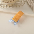 Close-up of cute biscuit hair clip with blue plaid bow on a creamy decorative tray - Bowknot Biscuit-Square