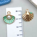 Cartoon shell alloy charm with green enamel and pearl in gold finish, shown with ruler - Light Green Pearl Shell