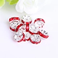 Macro detail of silver alloy spacer beads with sparkling red rhinestones for DIY jewelry - Silver Plated Red