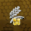 Detail of radiant cut yellow diamond ring with crystal leaf accents and pavé band - Adjustable Open / Yellow Normal Cut