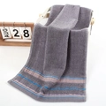 Absorbent dark grey cotton towel featuring colorful parallel stripes on a basket edge - Weak Twist Herringbone Grey / 34*74cm