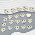 Detailed view of golden heart pendants with blue eye enamel designs on wave background - Style YJ13-06