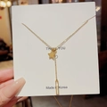 Golden necklace with star and rectangular shell pendant on a white gift card - Star Mother of Pearl Style / Gold