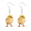 Detailed close-up of cute yellow chick acrylic earrings with silver hooks on white background - Chicken