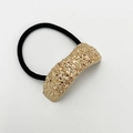 Detailed shot of golden hammer-textured metal buckle on a black elastic hair tie - Sand Rose Gold Type 2