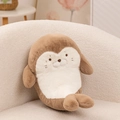 Soft plush seal doll in light brown and cream white on a cozy fleece chair - Seal