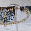 Detailed view of golden butterfly charms on a delicate metal chain belt for women - Butterfly Design / Gold