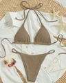 Flat lay of brown ribbed halter bikini top and high-cut bottom with vacation props - Brown