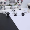 Macro detail of paw print pattern wooden beads for DIY pet jewelry and crafts - Black Double-Sided Paw Print
