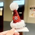 Close-up of a festive red sequin Christmas hat hair clip with white plush trim and snowflake - Lamb Fleece 3D Hat Clip - Heart