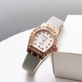 Macro detail of rose gold horseshoe watch case with luxury rhinestones and gray leather strap - Gray