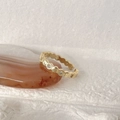 Gold honeycomb ring with clear gemstones on a red agate stone background - Honeycomb Hexagon