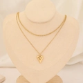 Detail of a gold double-layer necklace featuring a snake chain and a 3D heart pendant - 3D Heart Snake Chain Style (10#)