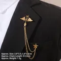 Detailed view of Baroque gold winged star brooch with chain on black suit lapel - Winged Cross Star Style (TL24023)