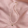 Baroque freshwater pearl necklace with gold star engraved square pendant on pink silk - Rectangle