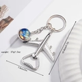 Silver airplane bottle opener keychain with blue-yellow star glass dome insert - Mercury Galaxy
