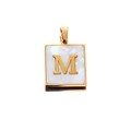 Macro view of square gold stainless steel pendant with letter M and white shell inlay - Gold M