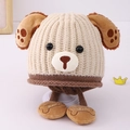Detail of baby knitted hat with dog ears and bone pendant featuring BABY text engraving - 3-8 Years / Beige