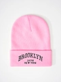Detailed close-up of pink knit hat with black Brooklyn 1898 New York embroidery - One Size / Pink
