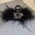Close-up of black feather hair claw clip with a sparkling rhinestone flower detail - Hair Claw-Black-Small