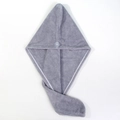 Detail view of the gray coral fleece hair towel featuring a secure button closure and texture - Gray
