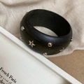 Detail of vintage wooden bangle featuring silver star rivets and geometric metal studs - Star and Dot Rivet Style / Black With Silver Rivets