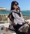 Ethnic printed sun protection shawl with floral pattern shown on a sunny beach balcony - Black and White Large Floral (Daisy-3)