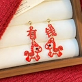 Macro shot of silver needle horse earrings with festive red enamel and gold finish - Silver Needle-Rich Horse Style(HE30336) / Red Gold