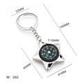 Polished star-shaped metal compass keychain with black and green dial on white background - Five-pointed Star Compass