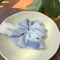 Close-up of light blue scrunchie with HELLO cloth label and purple heart paperclip - Haze Blue - Pink Paperclip Plain Gauze Scrunchie