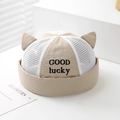 Detailed macro view of beige mesh cat ear hat with GOOD lucky embroidery and breathable fabric - 50cm (1-3 Years) / Off White