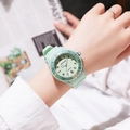 Close-up of mint green kids watch with round dial and silicone strap on a model's wrist - Light Green