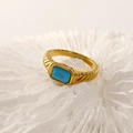 Detailed macro shot of 18k gold vintage ring with engraved texture and blue gemstone - Gold Turquoise Zirconia