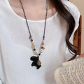 Close-up of black horse pendant necklace with colorful beads and woven rope chain - 22# Necklace Black Money Bag Pony