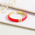 Detailed shot of 18K gold plated ring with vibrant red enamel and sparkling zircon - Adjustable Open / Red