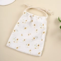 Detail of floral printed muslin cotton drawstring bag with beige rope closure and soft texture - Small Yellow Flower