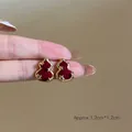 Detail shot of red velvet gourd earrings with gold star patterns, approx 1.2cm x 1.2cm - Red Gourd Gold Border Star Studs (4#银针-金色-红色)