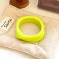 Minimalist wide resin bangle in vibrant neon yellow with a smooth rounded arc surface - Geometric Rhombus / Inner Diameter 65mm / Neon Yellow