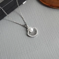 Silver shell pendant necklace with white pearl and zircons on grey textured surface - Single Shell Pearl-Silver 0376Y