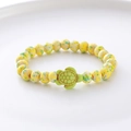 Macro shot of turquoise beads and a green turtle pendant on a handmade bracelet - Yellow Green Spotted Green Turtle Bracelet