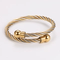 Macro detail of bicolored spiral twisted steel bangle with metallic ball ends - 5mm Two-Tone Gold