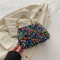 Colorful sequin crossbody bag with gold chain strap on a white blazer background - Colorful