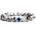 White marble bead bracelet featuring a vibrant blue evil eye charm and silver spacers - Tiger Skin Stone