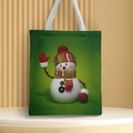 Close-up of a green canvas tote bag featuring a cute snowman holiday print - Style 10