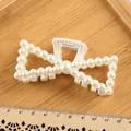 Elegant large bow hair claw clip featuring white pearls on a light wooden display tray - Double Triangle Hollow