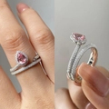 Fashionable pink pear-cut double ring with pave-set diamonds shown on model and held sideways - US 8 / Silver