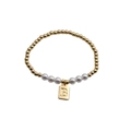 Close-up of gold beads and white pearls bracelet with a square letter B charm - Letter B