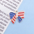 Enameled bow pendant featuring the USA flag design and gold-tone metal borders - Enamel US Flag Bow / 16x13mm