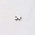 Macro view of a polished stainless steel puzzle-shaped pendant for jewelry making - 10*10mm / Steel