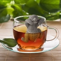 Funny gray sloth silicone tea infuser hanging on the edge of a white ceramic mug - Sloth Shape